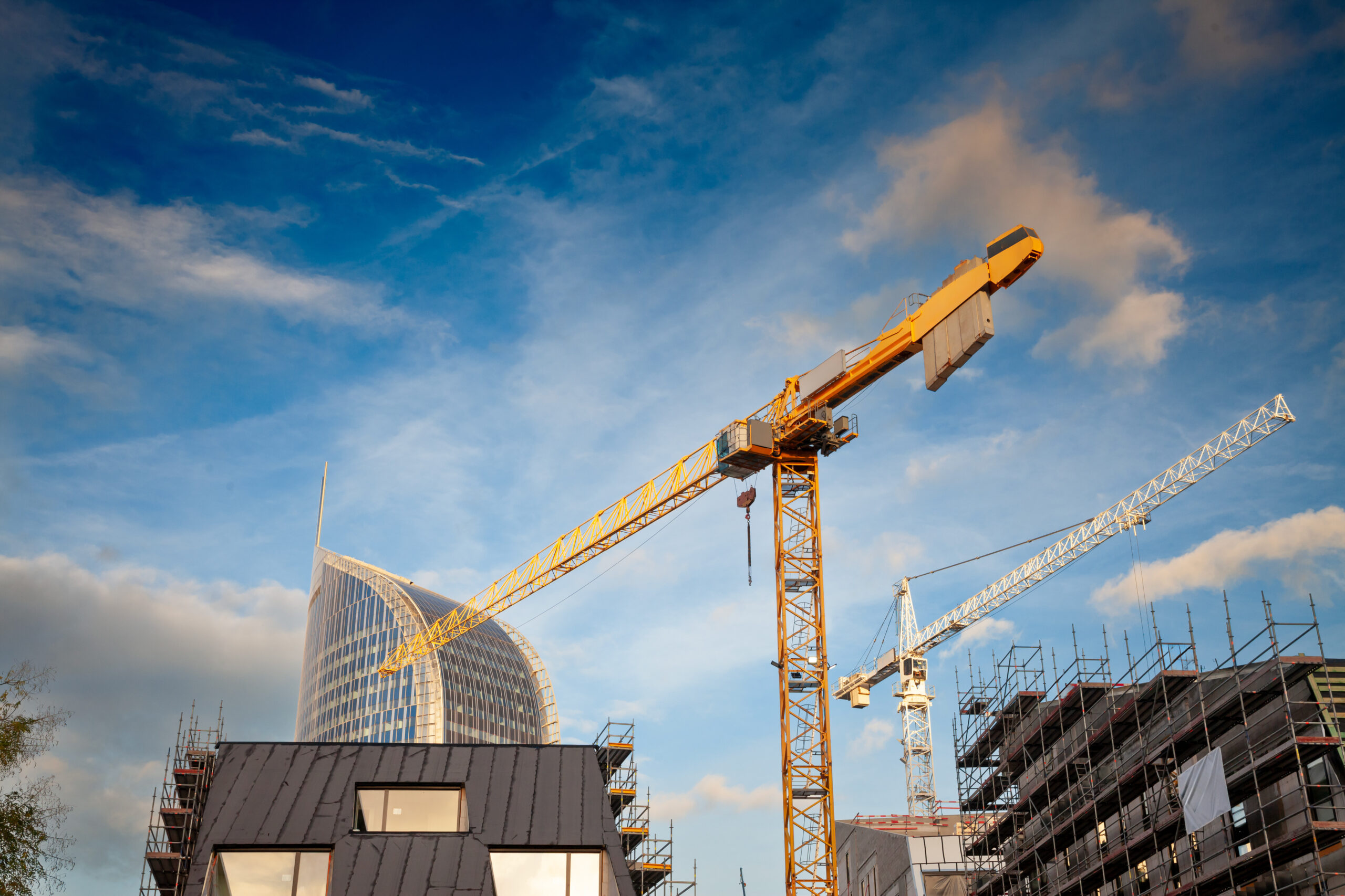 Cranes operating in construction site