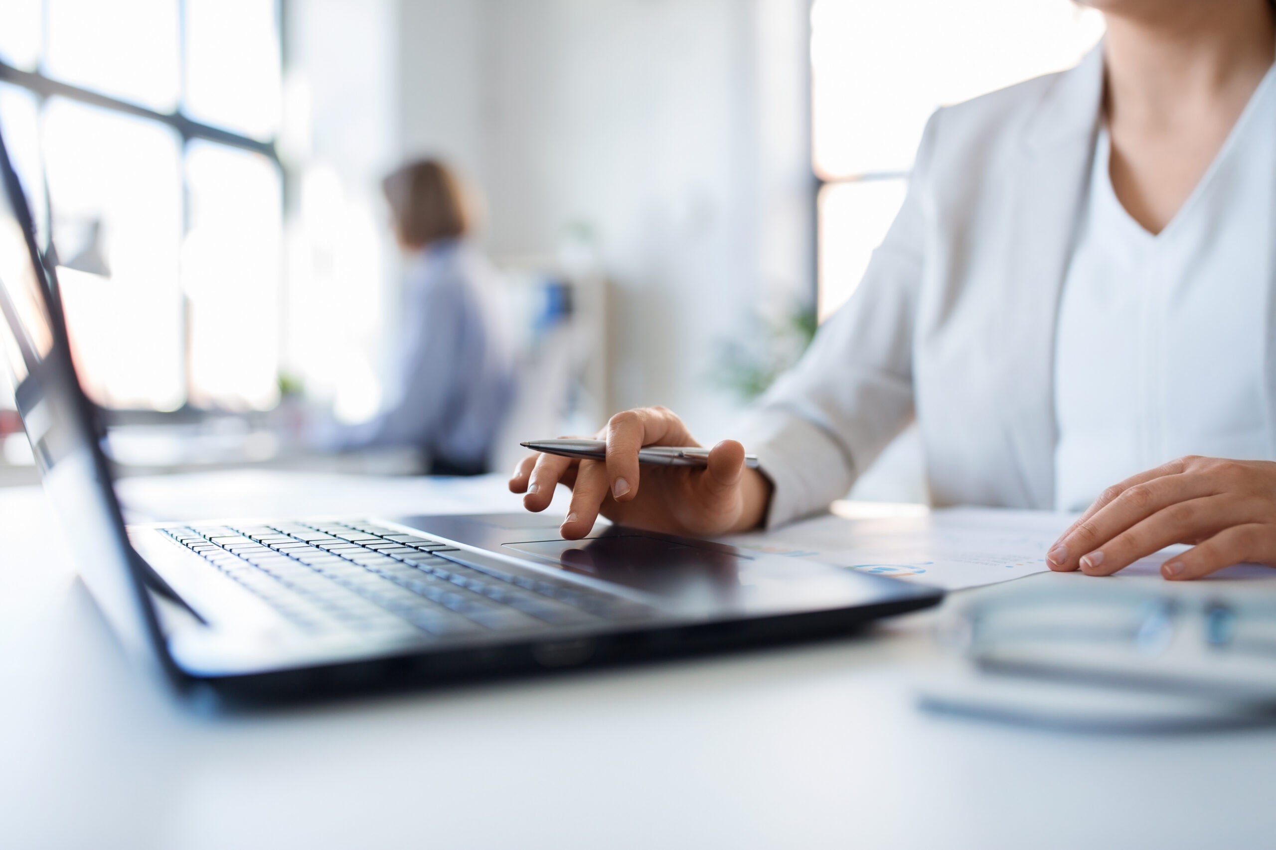 Woman using computer mouse on laptop