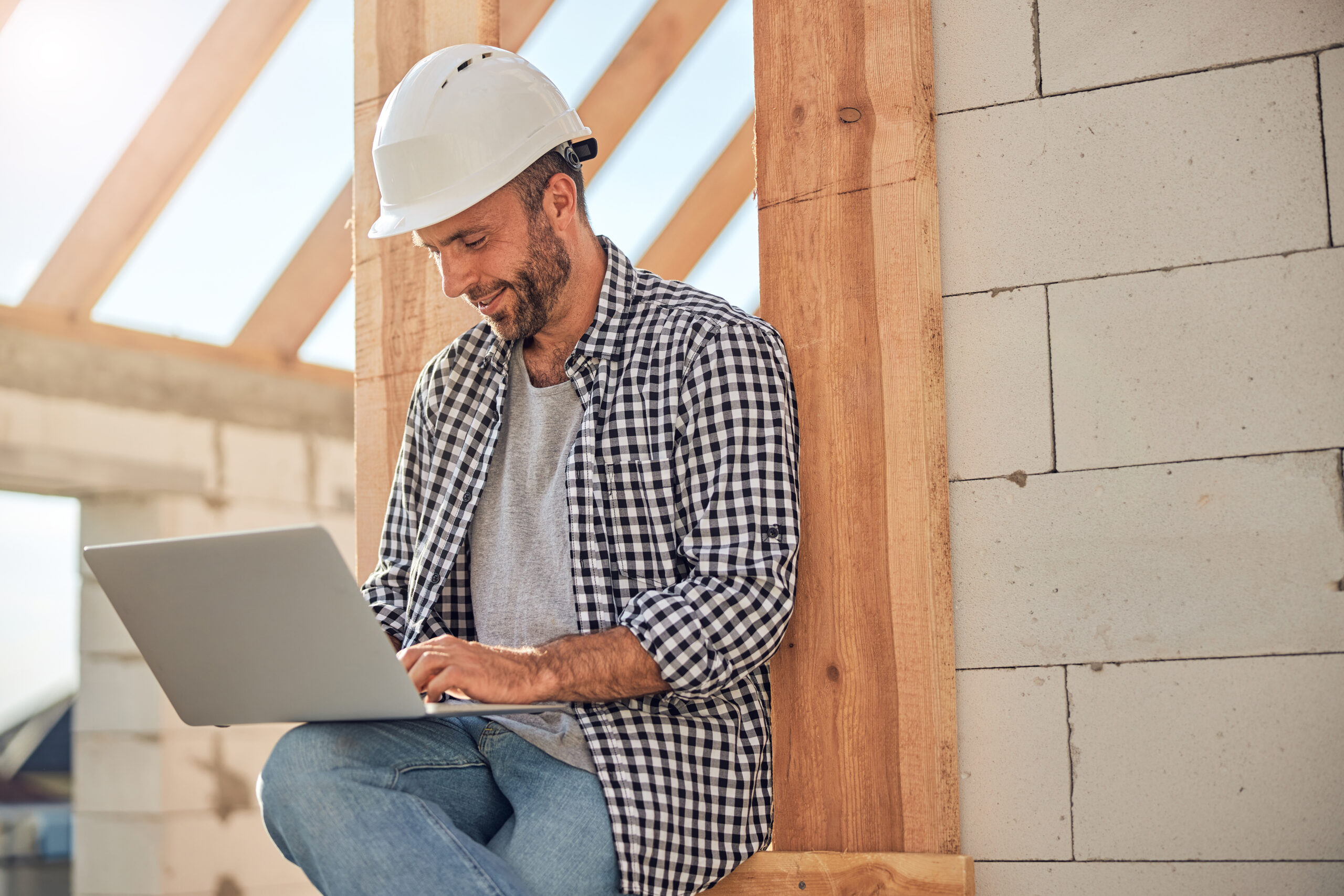 Construction worker working on laptop